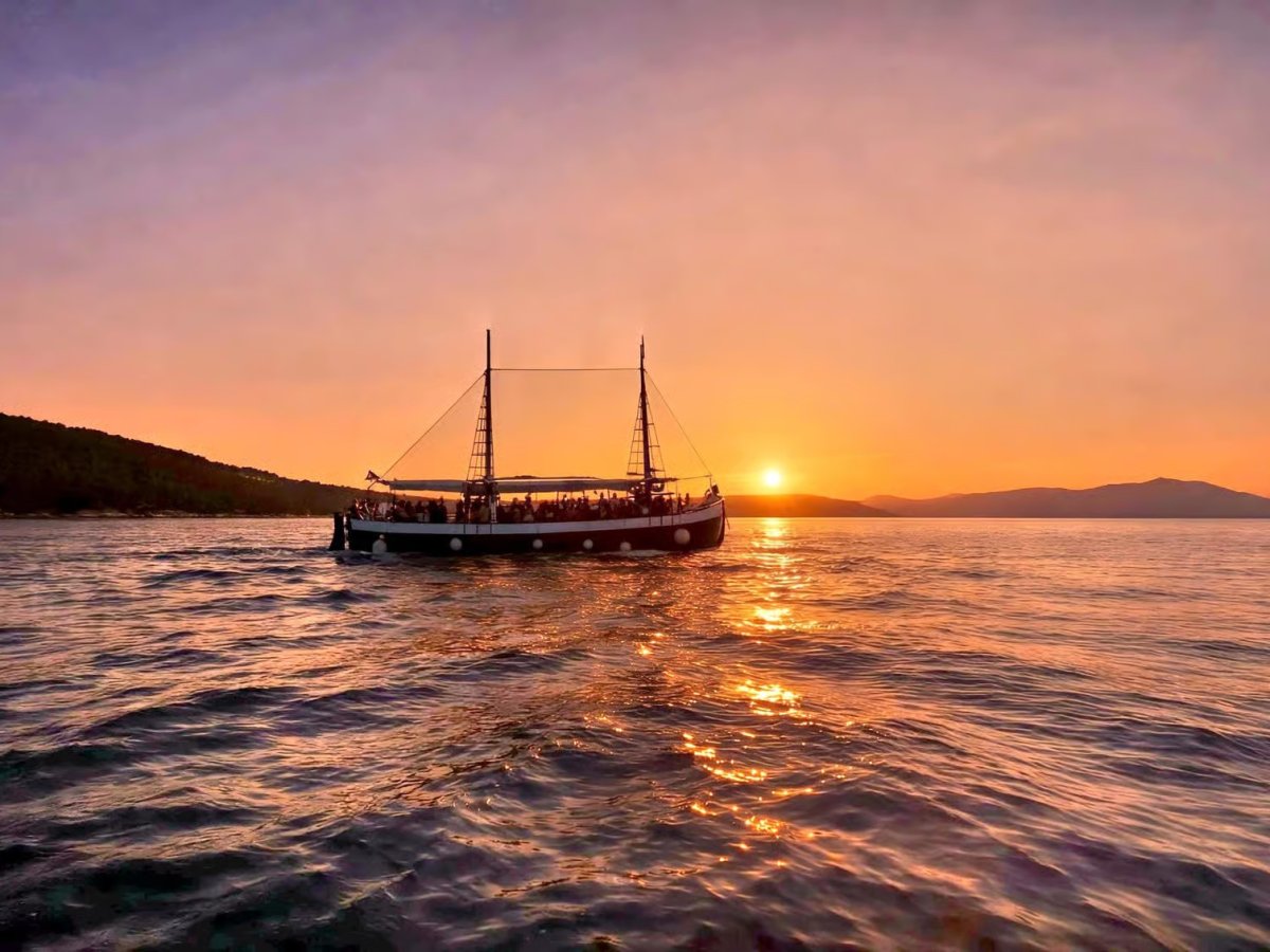 Guests on an antique wooden boat sunset cruise from Split